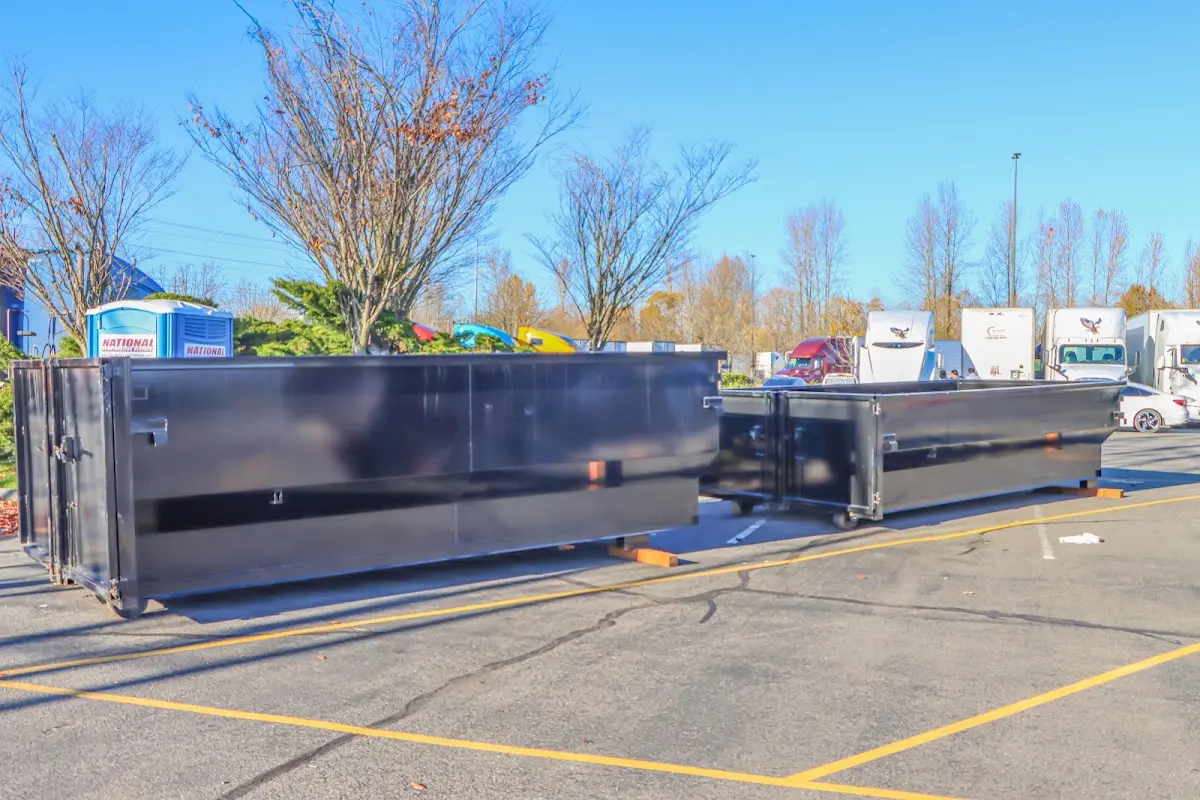 Professional dumpster rental service with roll-off container on residential driveway in Baltimore Highlands